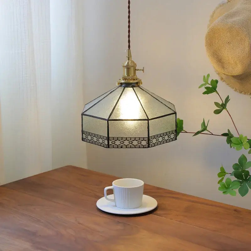 Vintage amber glass led pendant light featuring an octagonal pendant light with brass and dark metalwork accents