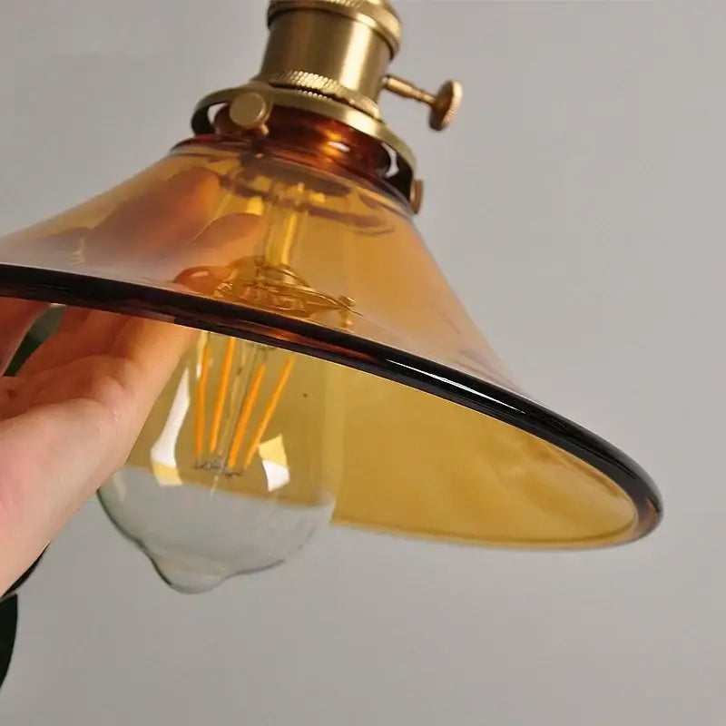 Vintage amber glass led pendant light with brass hardware and visible filament bulb for kitchen decorbites amber glass