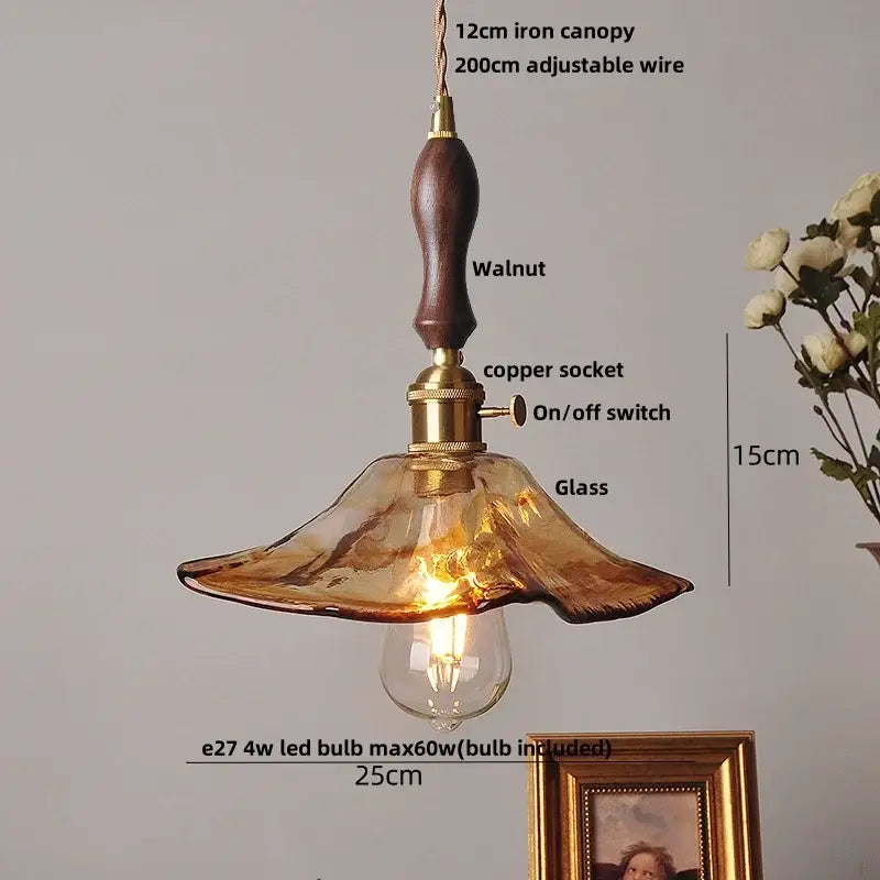 Warm amber glass led pendant light with brass accents and walnut-finished iron canopy for kitchen decorbites amber glass decor