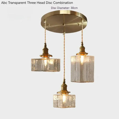 Vintage amber glass pendant light with transparent textured glass pendant shades and polished brass accents for dining room