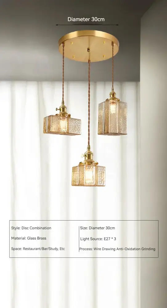Vintage amber glass pendant light with gold-toned brass disc fixture and three textured glass pendant shades