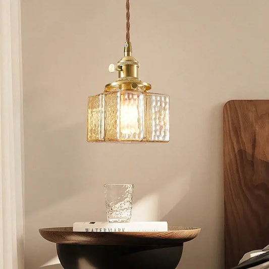 Vintage amber glass pendant light with gold-toned brass and textured amber glass panels for dining room use