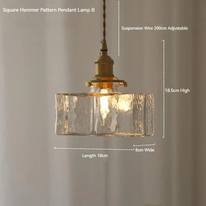 Vintage amber glass pendant light featuring a square hammer pattern with clear textured glass and polished brass hardware