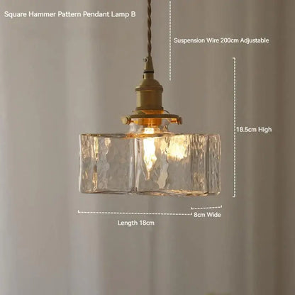 Vintage amber glass pendant light featuring a square hammer pattern with clear textured glass and polished brass hardware