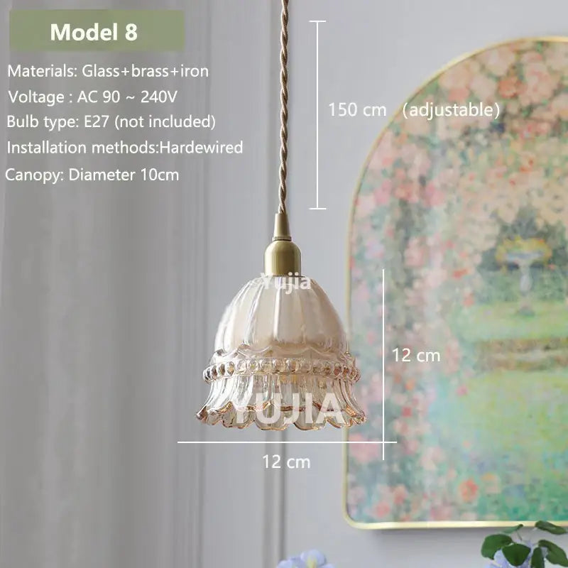 Delicate amber glass pendant light with fluted design and brass accents hanging from adjustable cord for kitchen island