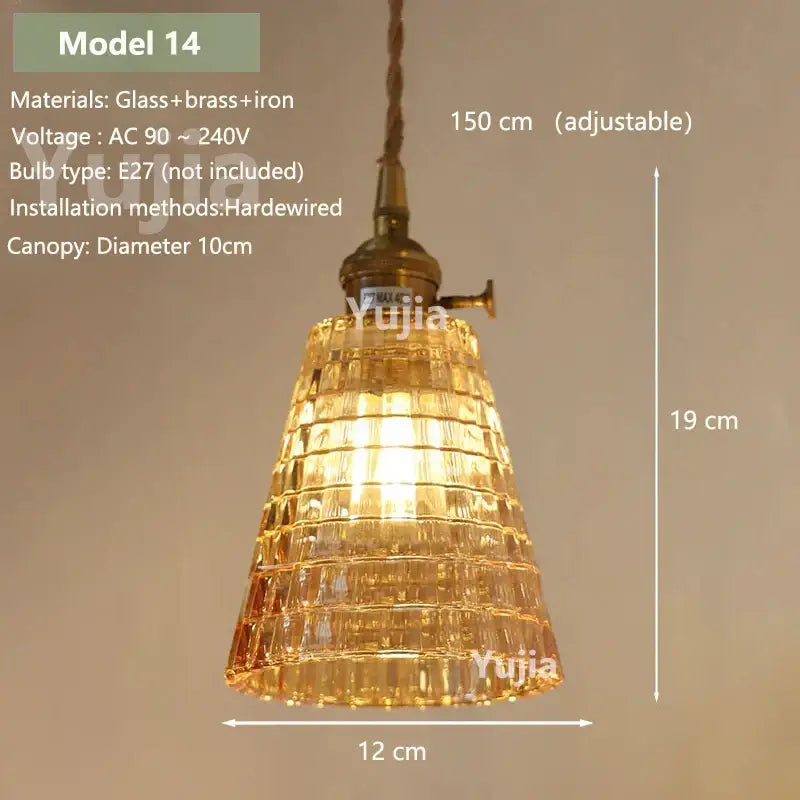 Vintage amber glass pendant light with brass and iron fixture featuring tiered design for kitchen island illumination