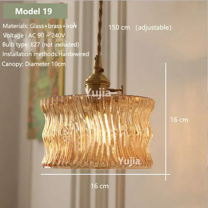 Model 19 is a warm-toned amber glass pendant light with wavy design and brass iron hardware for kitchen island lighting
