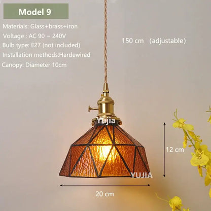 Model 9 pendant light made of warm amber glass with brass and iron geometric patterns for kitchen island lighting