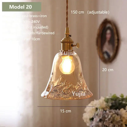 Vintage amber glass pendant light with textured bell-shaped shade and brass hardware for kitchen island lighting