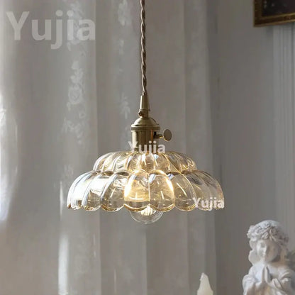 Vintage amber glass pendant light with brass finish and scalloped shade for kitchen island lighting
