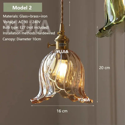 A warm amber glass pendant light with brass and iron flower-shaped fixture for kitchen island illumination
