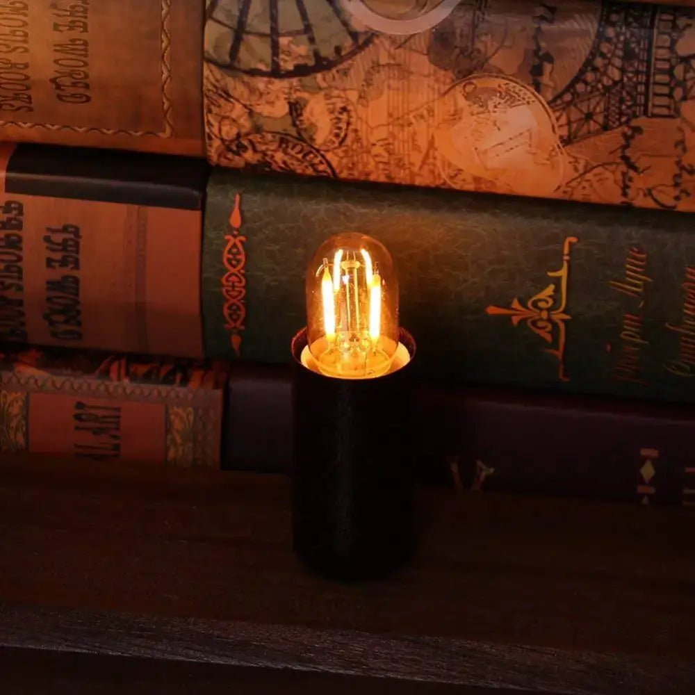 Warmly glowing vintage amber led bulb with clear glass dome and brass silver base for home decor and decorbites dimmable led use