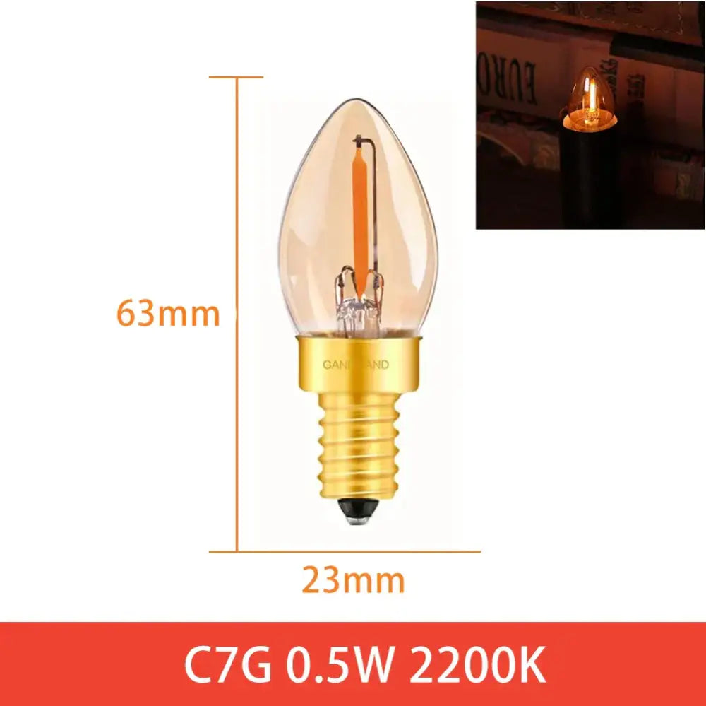 A clear c7g led bulb with an orange filament and golden base for vintage home decor and decorbites dimmable led lighting