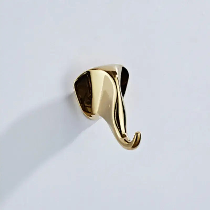 Gold-colored sleekly polished brass robe hook shaped like an elephant head and trunk vintage animal decorbites brass robe hooks