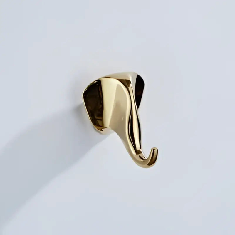 Gold-colored vintage animal brass robe hook shaped like a sleek polished elephant with a curved hanging end for decorbites brass robe hooks