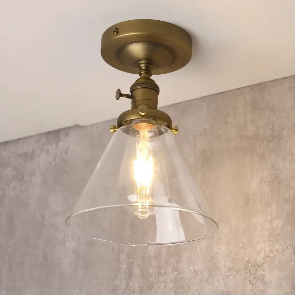 Brass-finished vintage antique decorbites funnel glass wall sconce with clear conical shade and exposed filament bulb