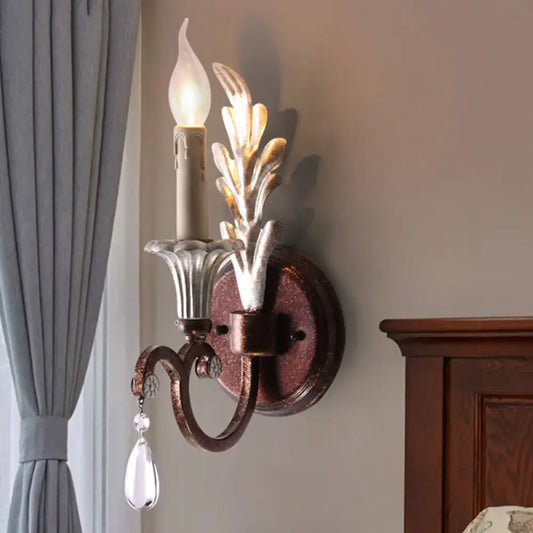 Vintage antique brass and silver leaf wall light fixture with clear crystal droplet pendant for bedroom use
