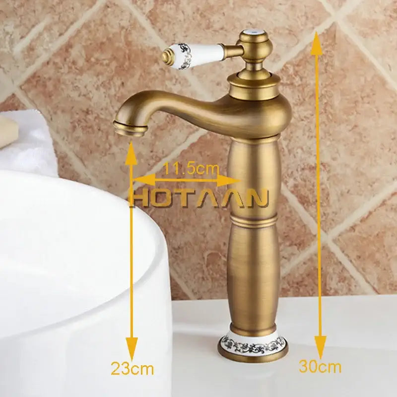 Vintage antique brass single hole bathroom faucet with white ceramic handle featuring black floral detailing and brass housing material