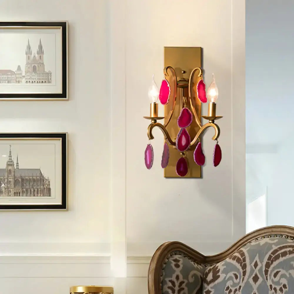 Vintage antique gold wall lamp sconce with two lit bulbs and dark purple clear geode-like stone accents