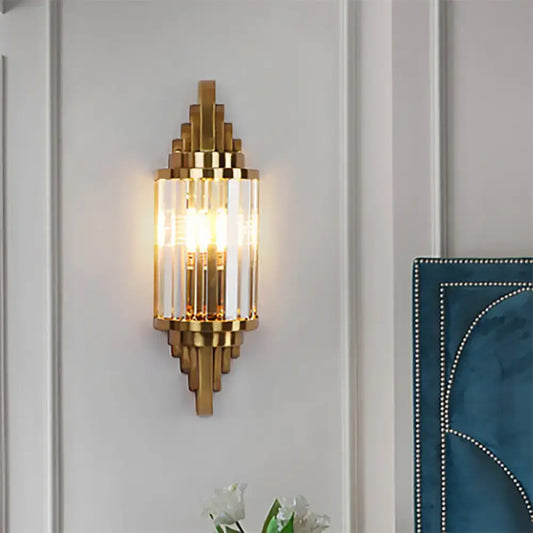 Gold-toned vintage art deco wall sconce with clear crystal prisms and geometric metal framing for living room use