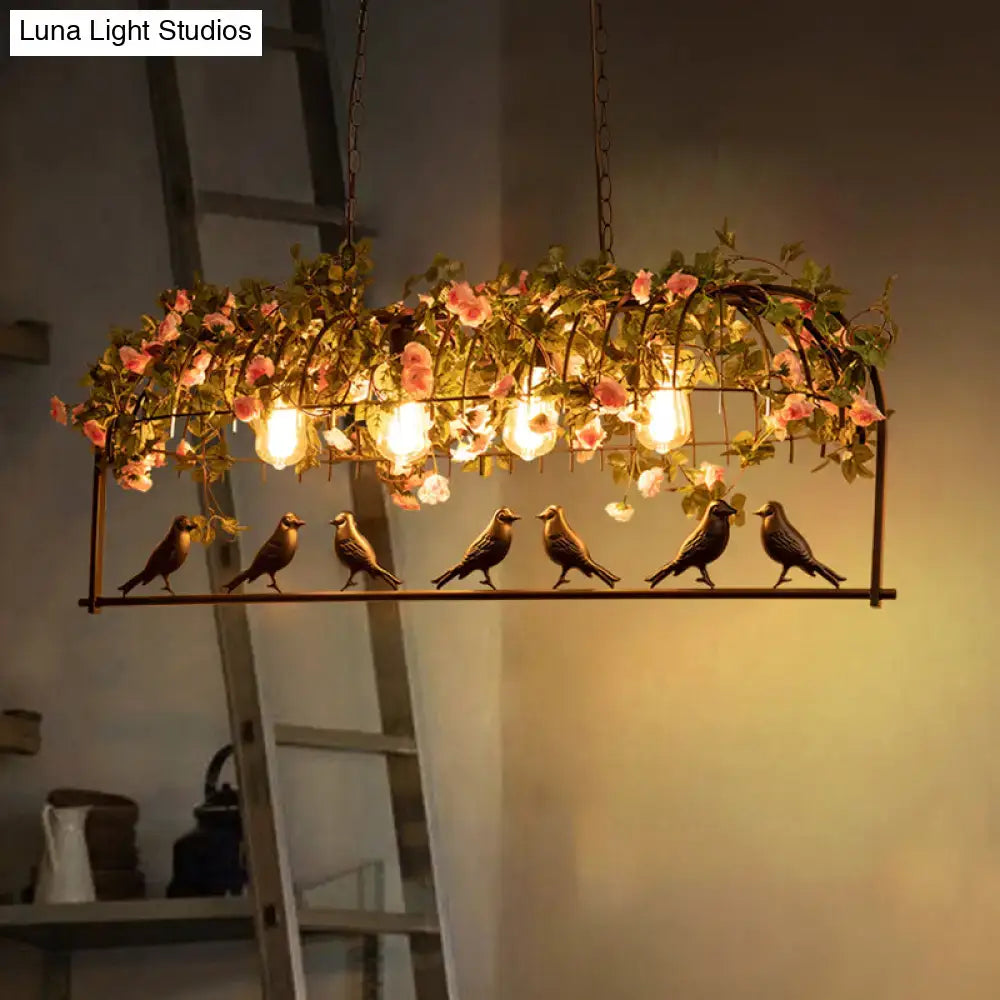 Vintage bird cage iron hanging light with six bronze birds, pink roses, and greenery for dining room decor