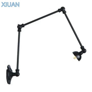 Vintage black adjustable loft wall light in industrial style with articulated arms and matte finish for bedroom use