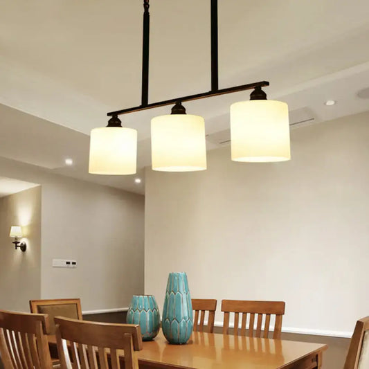 Vintage black metal bar island light with three off-white fabric shades for dining room white glass decor