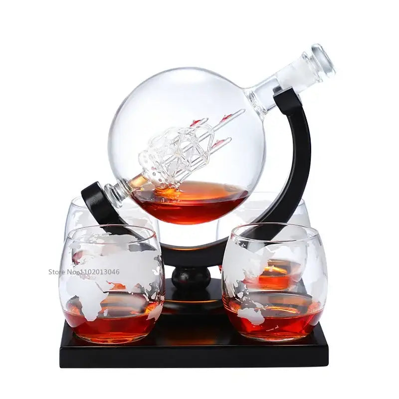 Clear glass earth decanter set with etched miniature ship and matching world-map glasses on black base for dining room