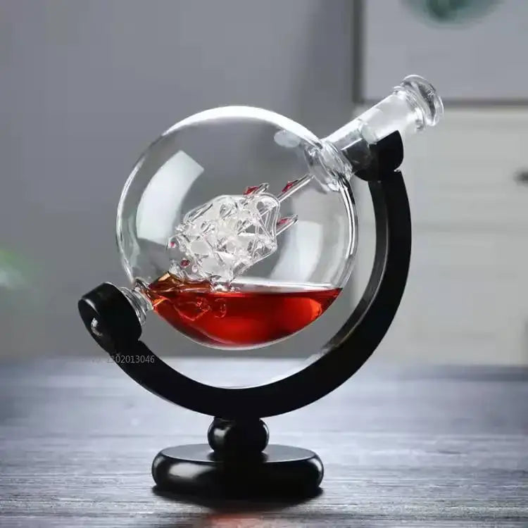 Clear glass vintage black earth decanter set with etched world map and crystal ship inside on black metal stand