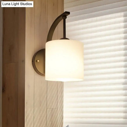 Vintage black glass wall lamp fixture type with matte brass base dark bronze curved arm and off-white frosted shade