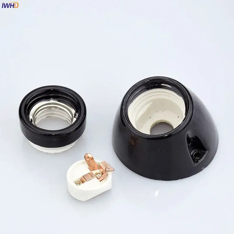 Vintage black glossy ceramic lamp holder socket with white interior and copper contacts for bedroom table light