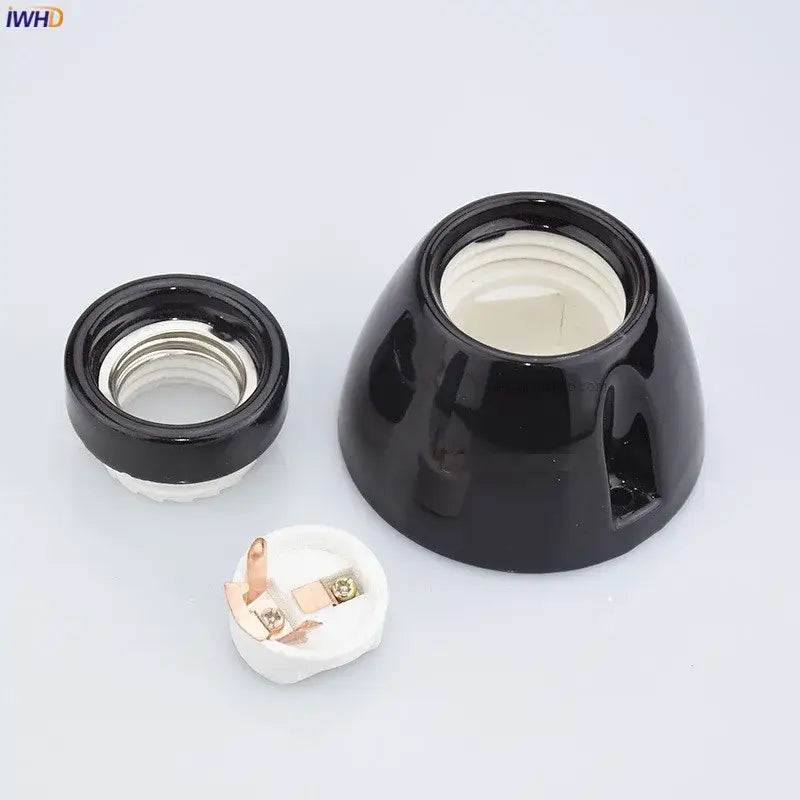 Vintage black glossy ceramic lamp holder socket with white interior and metallic contact points for bedroom table light