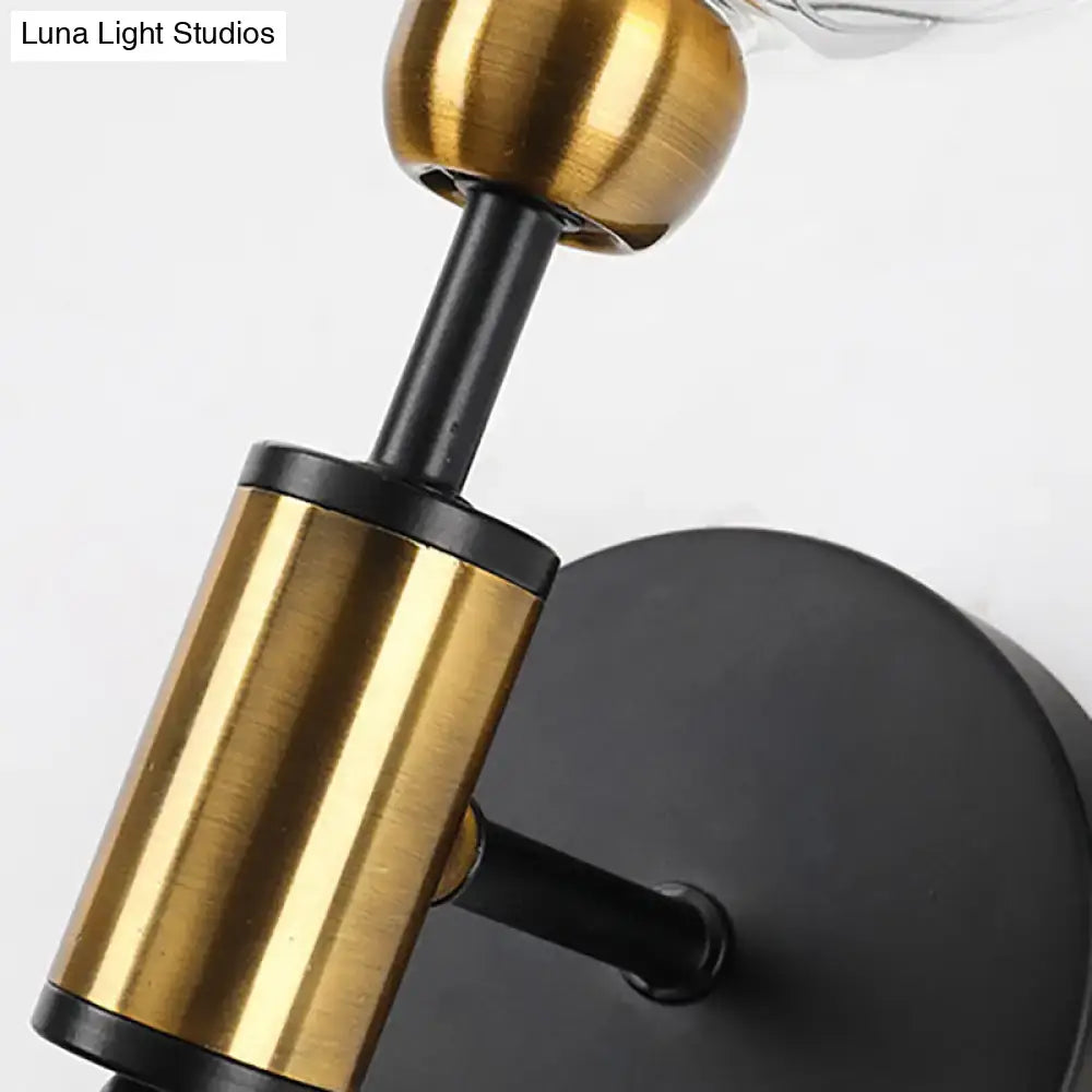 Vintage black and gold clear glass wall sconce with brushed brass finish mounted on matte black base for e26 e27 bulbs