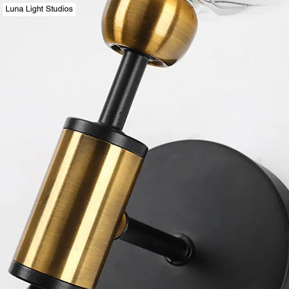 Vintage black and gold clear glass wall sconce with brushed brass finish mounted on matte black base for e26 e27 bulbs