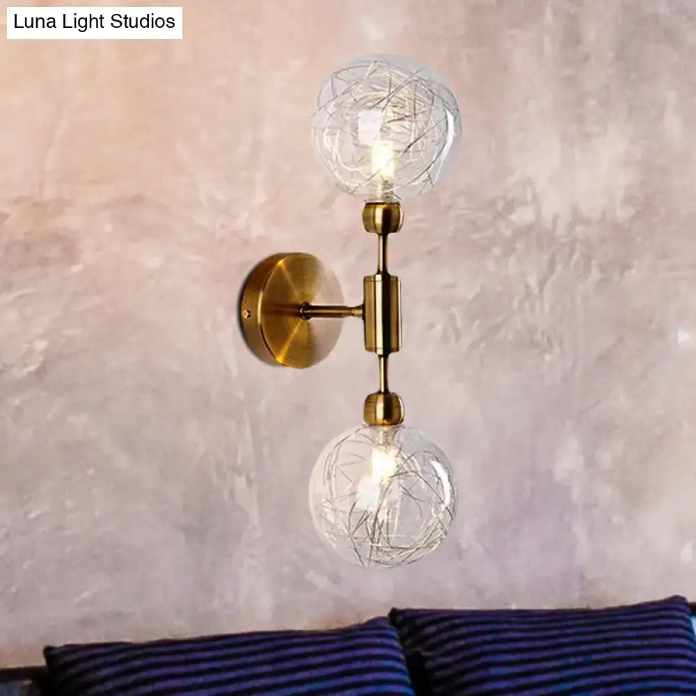 Brass-finished vintage wall sconce with clear glass e26 e27 globes and intricate wireframe design for bedroom lighting