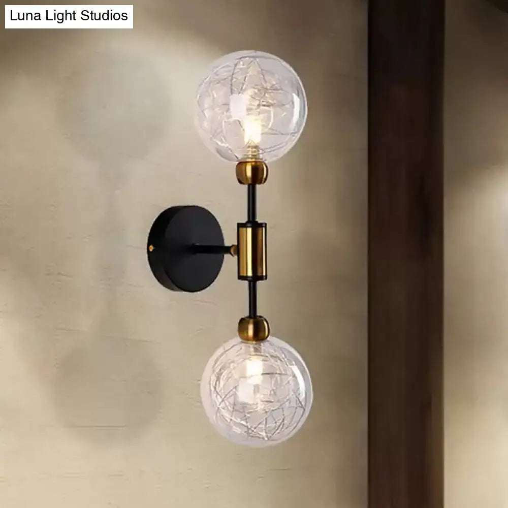 Modern vintage black and gold two-light wall sconce with clear glass globe shades and e26 e27 brass accents for bedroom use