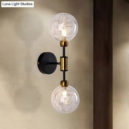 Modern vintage black and gold two-light wall sconce with clear glass globe shades and e26 e27 brass accents for bedroom use