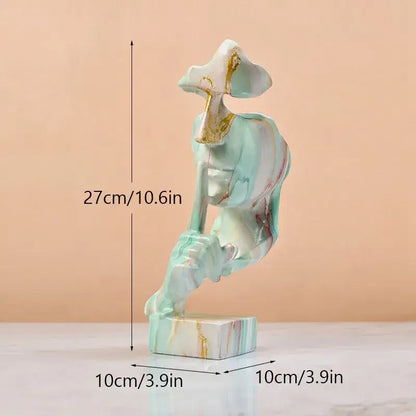 A 27cm silence golden face abstract sculpture in translucent mint-green resin with gold leaf accents for office decor