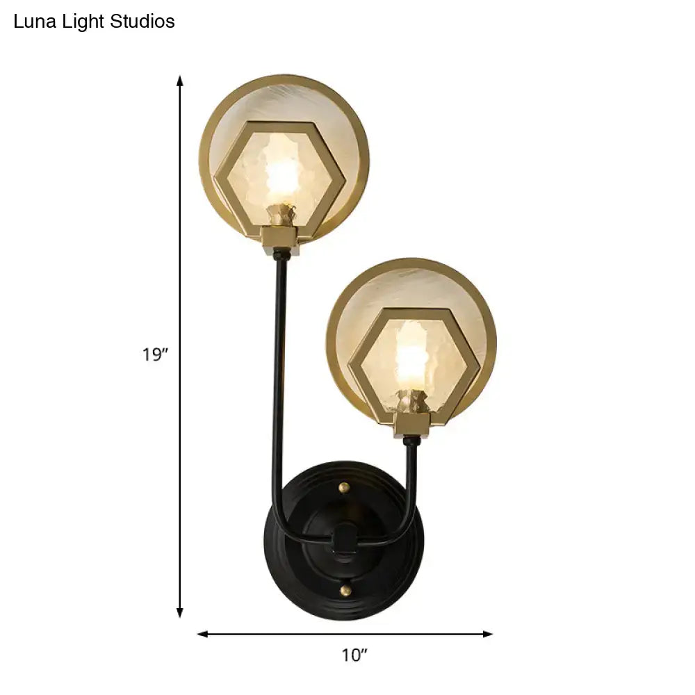 Vintage black metal wall lamp with gold-toned accents and hexagonal glass shades for elegant living space lighting