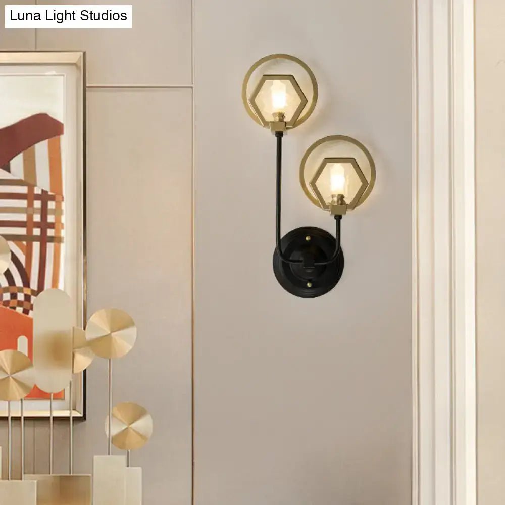 Modern two-light wall lamp with black finish metal arms and gold-toned hexagonal shades for living space lighting