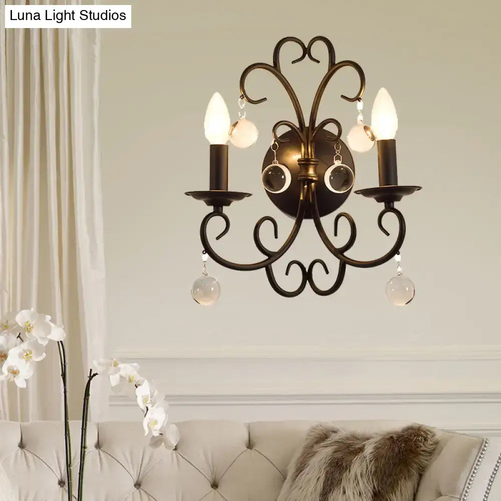 Vintage black iron wall light featuring antique bronze wrought iron three-arm sconce with crystal ball deco pendants