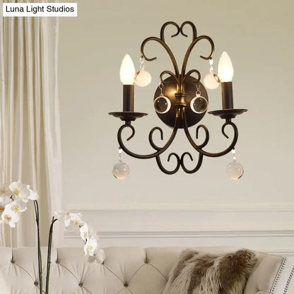 Vintage black iron wall light featuring antique bronze wrought iron three-arm sconce with crystal ball deco pendants