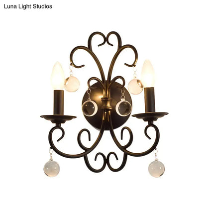 Antique bronze wrought iron wall light with two candle bulbs and crystal ball deco frosted glass orbs for living room
