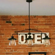 DecorBites vintage black metal chandelier with three clear glass pendant lights for clear glass island lighting