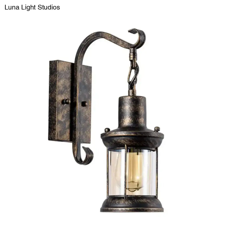Antique bronze-finished DecorBites coastal glass lantern wall sconce light fixture with filament bulb for dining room lighting
