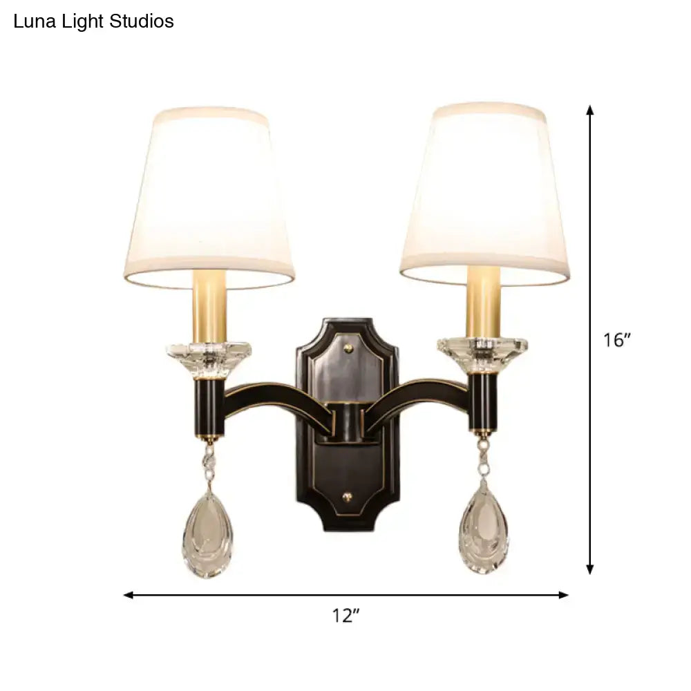 Vintage black metal wall lamp featuring two white lampshades and cut crystal teardrop pendants for bedroom use