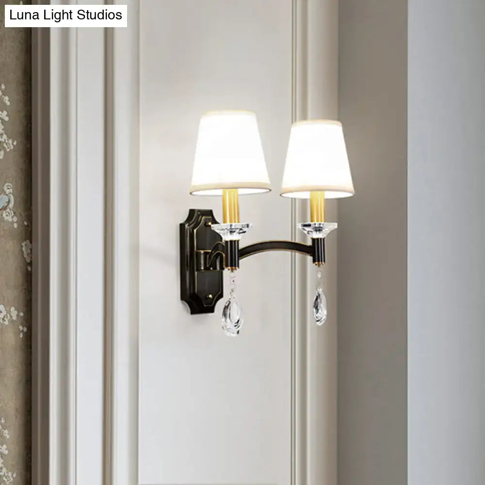 Elegant vintage black metal wall lamp with two white fabric shades and cut crystal teardrop accents for bedroom use