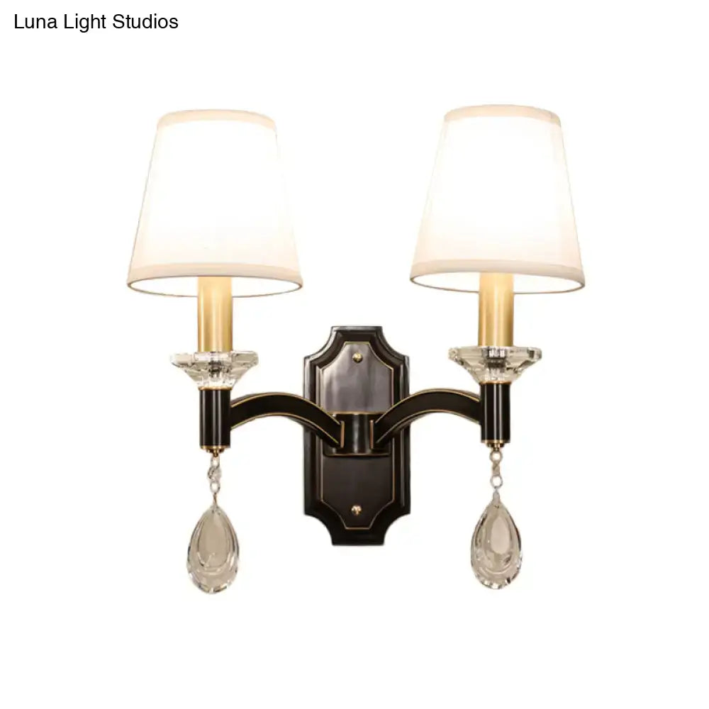 Elegant vintage black metal wall lamp with two white lampshades and cut crystal teardrop pendants for bedroom use