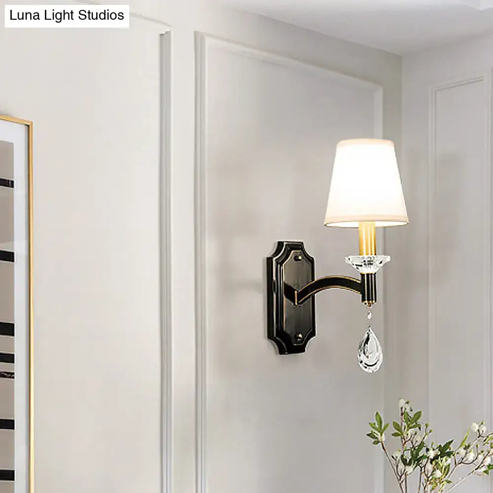 Elegant vintage black metal wall lamp with white fabric shade and cut crystal teardrop accent for bedrooms