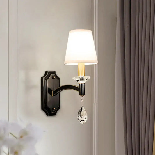 Vintage black metal wall lamp with white fabric shade and dangling cut crystal teardrop for bedroom décor